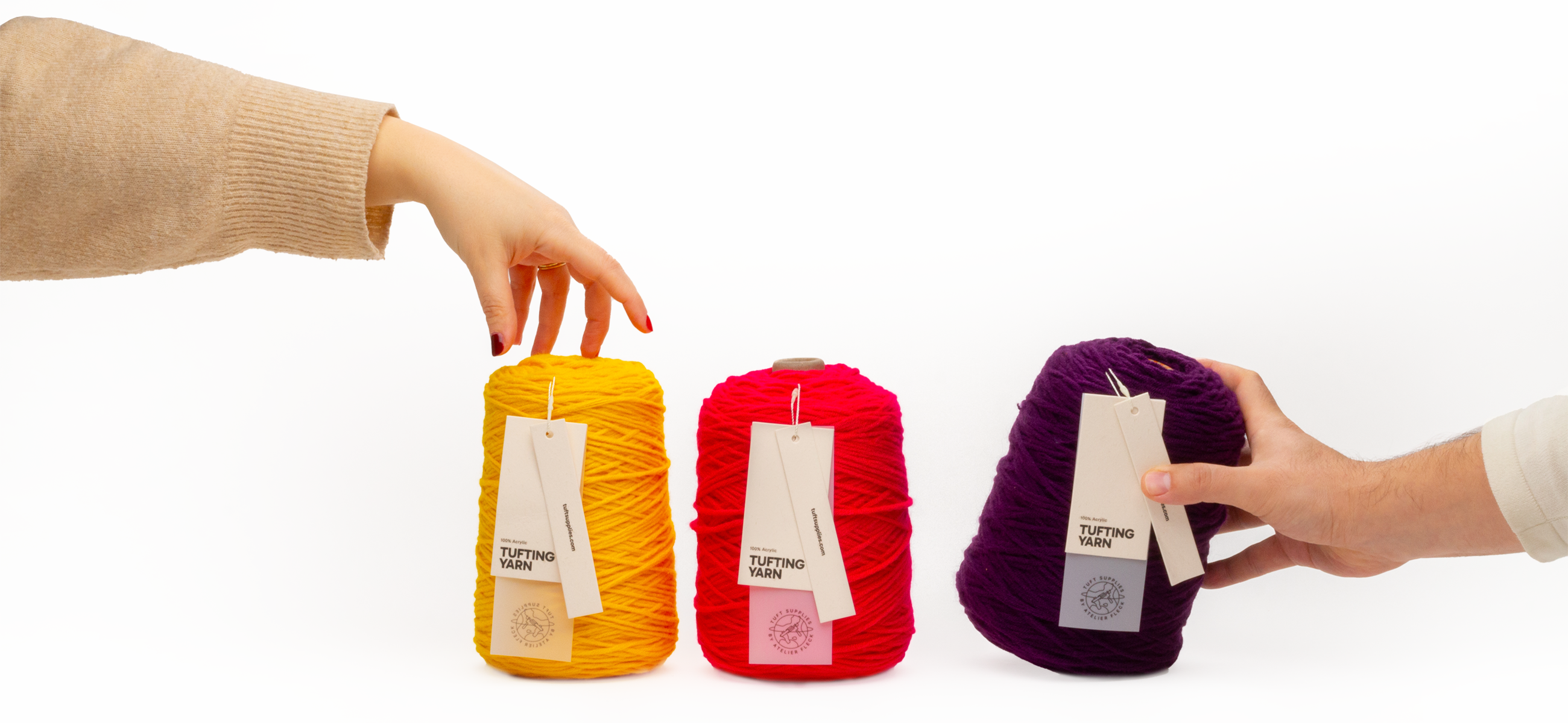 3 colors of acrylic yarn that 2 hands are taking